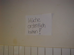 This sign reads: KEEP THE KITCHEN CLEAN AND ORDERLY!! ;-)